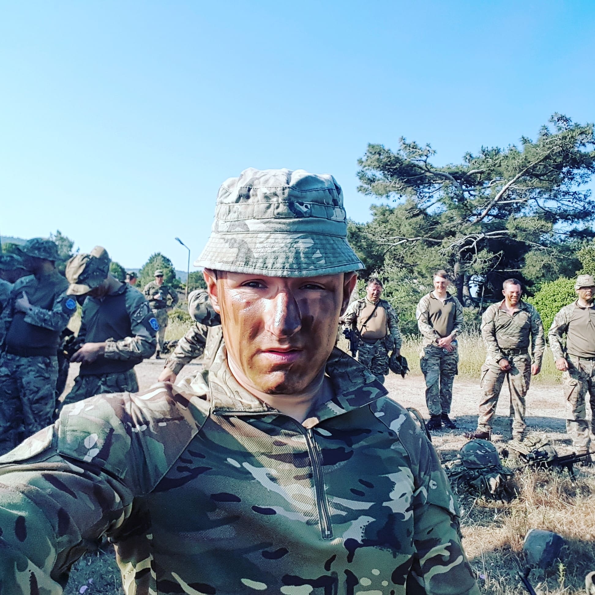 Soldier in camouflage faces camera